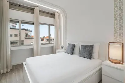 a white bedroom with a white bed and a window at Drapes Design Apartments by An Island Apart in Funchal