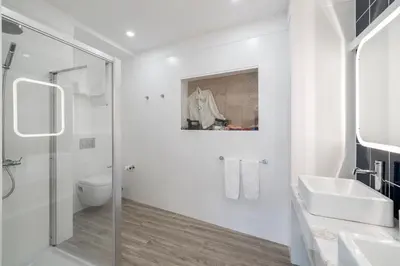 a bathroom with a shower and a toilet and a sink at Drapes Design Apartments by An Island Apart in Funchal