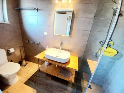 a bathroom with a sink and a shower at Casa do Tonel in Sagres