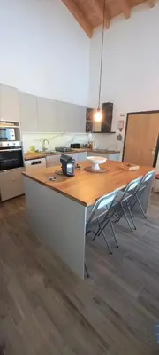 a kitchen with a large wooden table and chairs at Casa do Tonel in Sagres