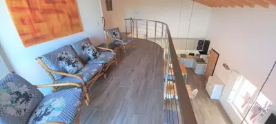a living room with blue couches and a staircase at Casa do Tonel in Sagres