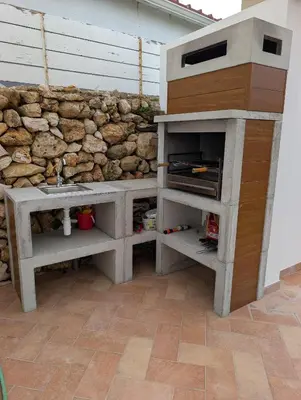 a stone wall with a sink next to a counter at Casa do Tonel in Sagres