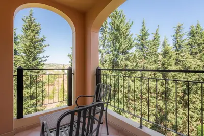 a dining room and living room with a table and chairs at Luz casas- BayLuz apart,pool,beach, tennis, wifi,aircon in Luz