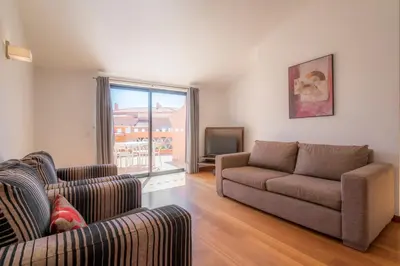 a hotel room with two beds and a mirror at Luz casas- BayLuz apart,pool,beach, tennis, wifi,aircon in Luz