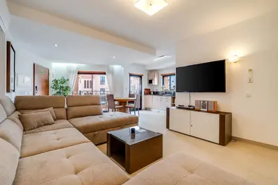 a bedroom with a large white bed with two lamps at Luz casas- BayLuz apart,pool,beach, tennis, wifi,aircon in Luz