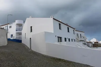 a group of white buildings on a street at Casa na Carrapateira, Aljezur in Carrapateira