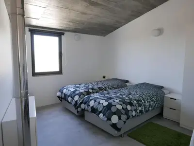 a bedroom with a bed and a window at Casa na Carrapateira, Aljezur in Carrapateira