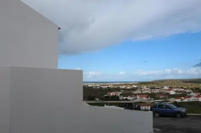 a car parked in a parking lot with a view of a city at Casa na Carrapateira, Aljezur in Carrapateira