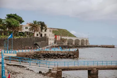 a pier in the water next to a body of water at Casa da Morena by Amazing Madeira in Santa Cruz