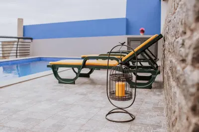 a cage with a baseball bat and a bench at Casa da Morena by Amazing Madeira in Santa Cruz
