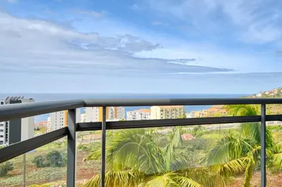 a balcony with a view of the ocean at Levada dos Piornais, a Home in Madeira in Funchal