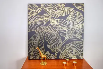 a giraffe figurine sitting on a table in front of a painting at Levada dos Piornais, a Home in Madeira in Funchal