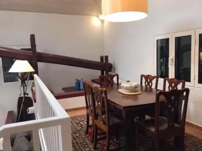 a dining room table and chairs in a room at GuestReady - Casa Avó Alice in Porto da Cruz