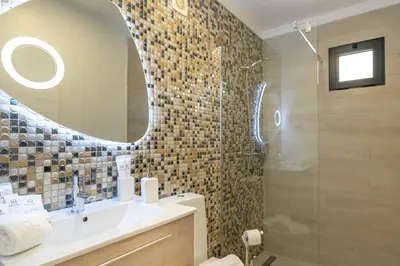 a bathroom with a sink and a mirror at Casa Mariana by Rent2U, Lda in Arco da Calheta