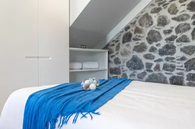a bedroom with a blue blanket on a bed at Casa Mariana by Rent2U, Lda in Arco da Calheta