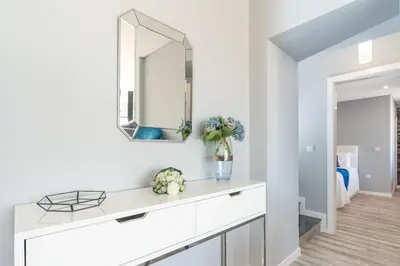 a white bathroom with a sink and a mirror at Casa Mariana by Rent2U, Lda in Arco da Calheta