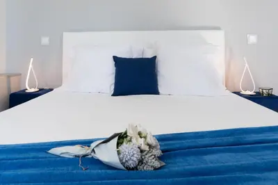 a bedroom with a bed with a blue blanket at Casa Mariana by Rent2U, Lda in Arco da Calheta