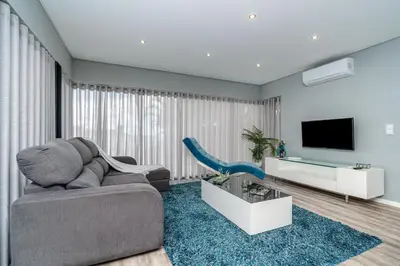 a living room with a couch and a tv at Casa Mariana by Rent2U, Lda in Arco da Calheta