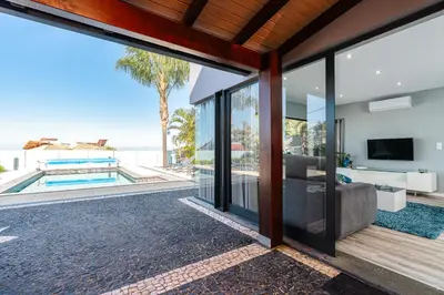an open living room with a view of the ocean at Casa Mariana by Rent2U, Lda in Arco da Calheta
