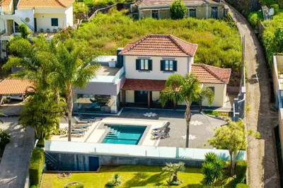 an aerial view of a house with a swimming pool at Casa Mariana by Rent2U, Lda in Arco da Calheta