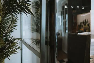 a glass door with the words smug on it next to a plant at City Garden by Madeira Best Apartments in Funchal
