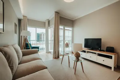 a living room with a couch and a flat screen tv at City Garden by Madeira Best Apartments in Funchal
