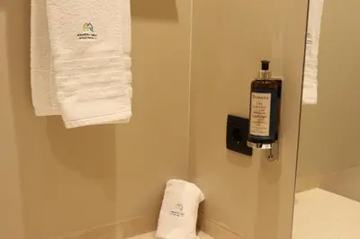 a bathroom with towels and a bottle of soap at City Garden by Madeira Best Apartments in Funchal