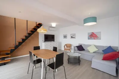a living room with a couch and a table at Seasky Arco in Arco da Calheta
