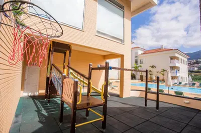two twin beds in a room with a window at FLH Funchal Modern Apartment with Pool in Funchal