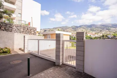 a living room with a table and a dining room at FLH Funchal Modern Apartment with Pool in Funchal