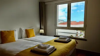 a swimming pool on a patio with a view of a city at FLH Funchal Modern Apartment with Pool in Funchal