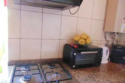 a microwave sitting on top of a table with food at Charming house in Machico with mountain view and garden in Machico