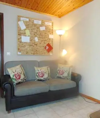 a living room with a couch and a table at Charming house in Machico with mountain view and garden in Machico