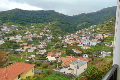 a view of a town with houses on a hill at Charming house in Machico with mountain view and garden in Machico