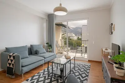 a living room with a blue couch and a glass table at Ilhéus IV by An Island Apart in Funchal