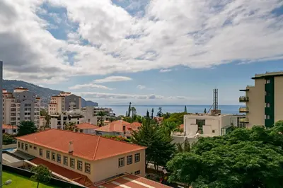 a city with buildings and the ocean in the background at Ilhéus IV by An Island Apart in Funchal