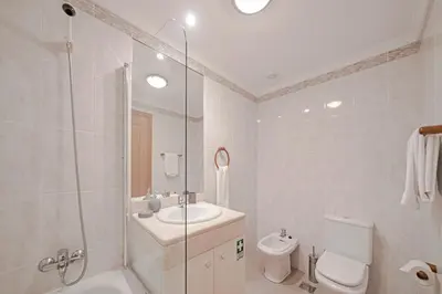 a bathroom with a sink and a toilet and a shower at Ilhéus IV by An Island Apart in Funchal