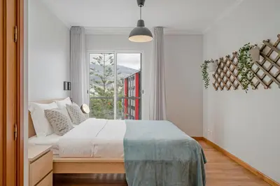 a bedroom with a bed and a window at Ilhéus IV by An Island Apart in Funchal