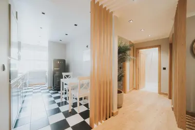 a kitchen and dining room with a black and white checkered floor at Cliff by Madeira Best Apartments in Funchal