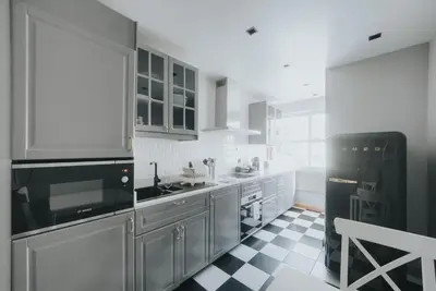 a kitchen with stainless steel appliances and a checkered floor at Cliff by Madeira Best Apartments in Funchal