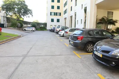 a row of parked cars parked in a parking lot at Cliff by Madeira Best Apartments in Funchal
