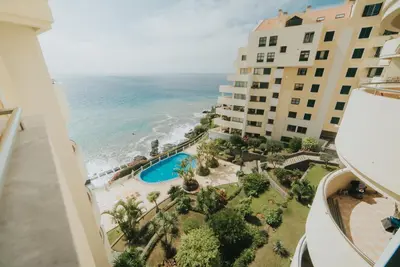 a view of the ocean from the balcony of a building at Cliff by Madeira Best Apartments in Funchal
