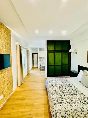 a bedroom with a bed and a wooden floor at VALE MAR Guest in Ribeira Brava