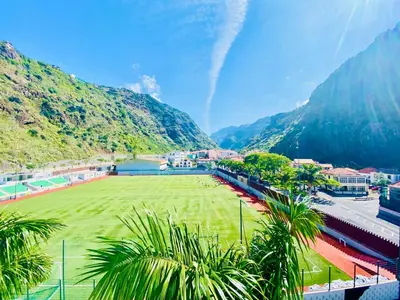 a soccer field with mountains in the background at VALE MAR Guest in Ribeira Brava