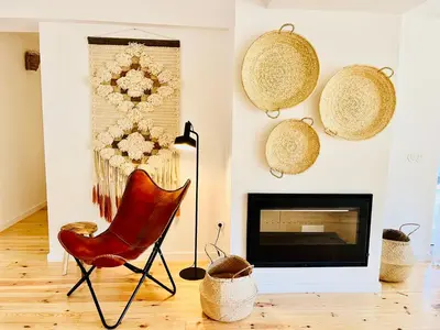 a living room with a chair and a fireplace at Salema Eco Camp - Sustainable Camping & Glamping in Salema