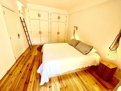 a bedroom with a bed and a wooden floor at Salema Eco Camp - Sustainable Camping & Glamping in Salema
