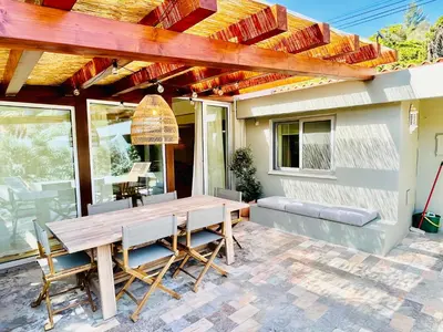 a patio with a wooden table and chairs at Salema Eco Camp - Sustainable Camping & Glamping in Salema