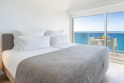 a bedroom with a bed with a view of the ocean at Escarpa - The Madeira Hideaway in Ponta do Sol