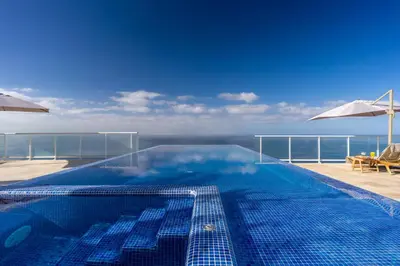 a swimming pool with a view of the ocean at Escarpa - The Madeira Hideaway in Ponta do Sol
