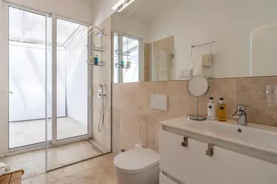 a bathroom with a shower and a toilet and a sink at Escarpa - The Madeira Hideaway in Ponta do Sol